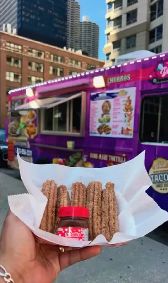 Fresh churros with Nutella in front of the Delicias purple churros truck in Chicago