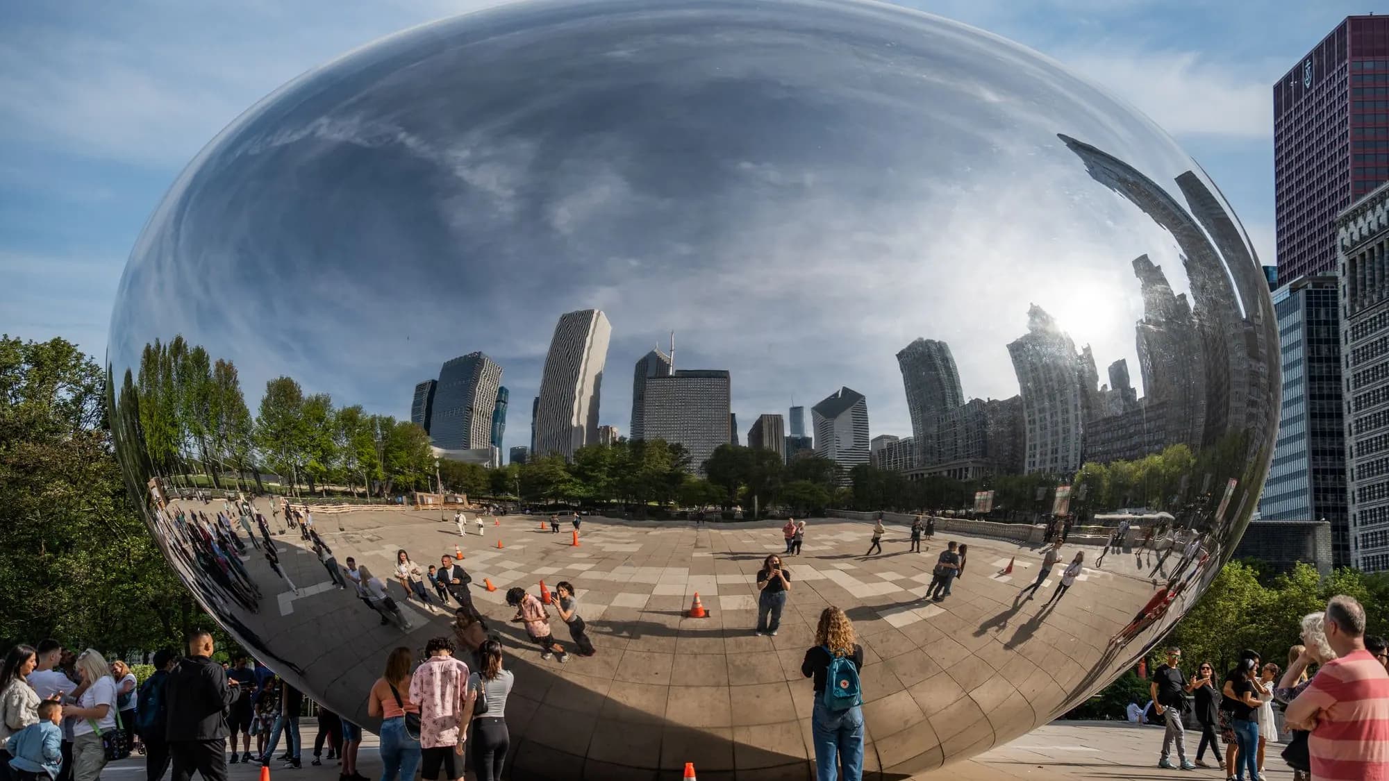 Cloud Gate in Millennium Park reflecting the Chicago skyline on a bright day