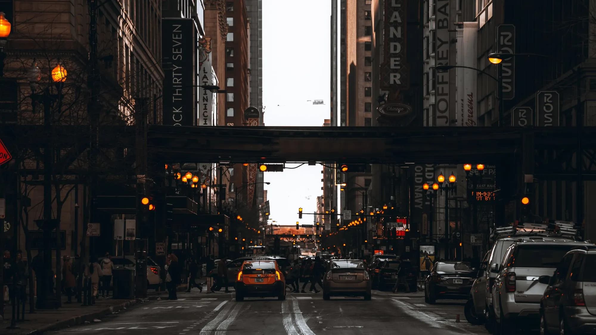 Chicago street at night lit by shopfronts and traffic lights